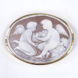 An oval relief carved cameo shell brooch, depicting 2 cherubs, in 18ct gold frame, panel length