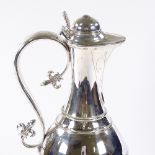 A large Victorian Gothic revival silver flagon, of baluster form, with fleur-de-lis handle terminals