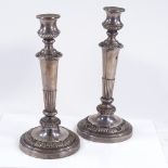 A large pair of silver plate on copper tapered candlesticks, of half-fluted form, with relief