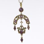 An Edwardian unmarked gold amethyst and green glass pendant necklace, with grapevine decoration,