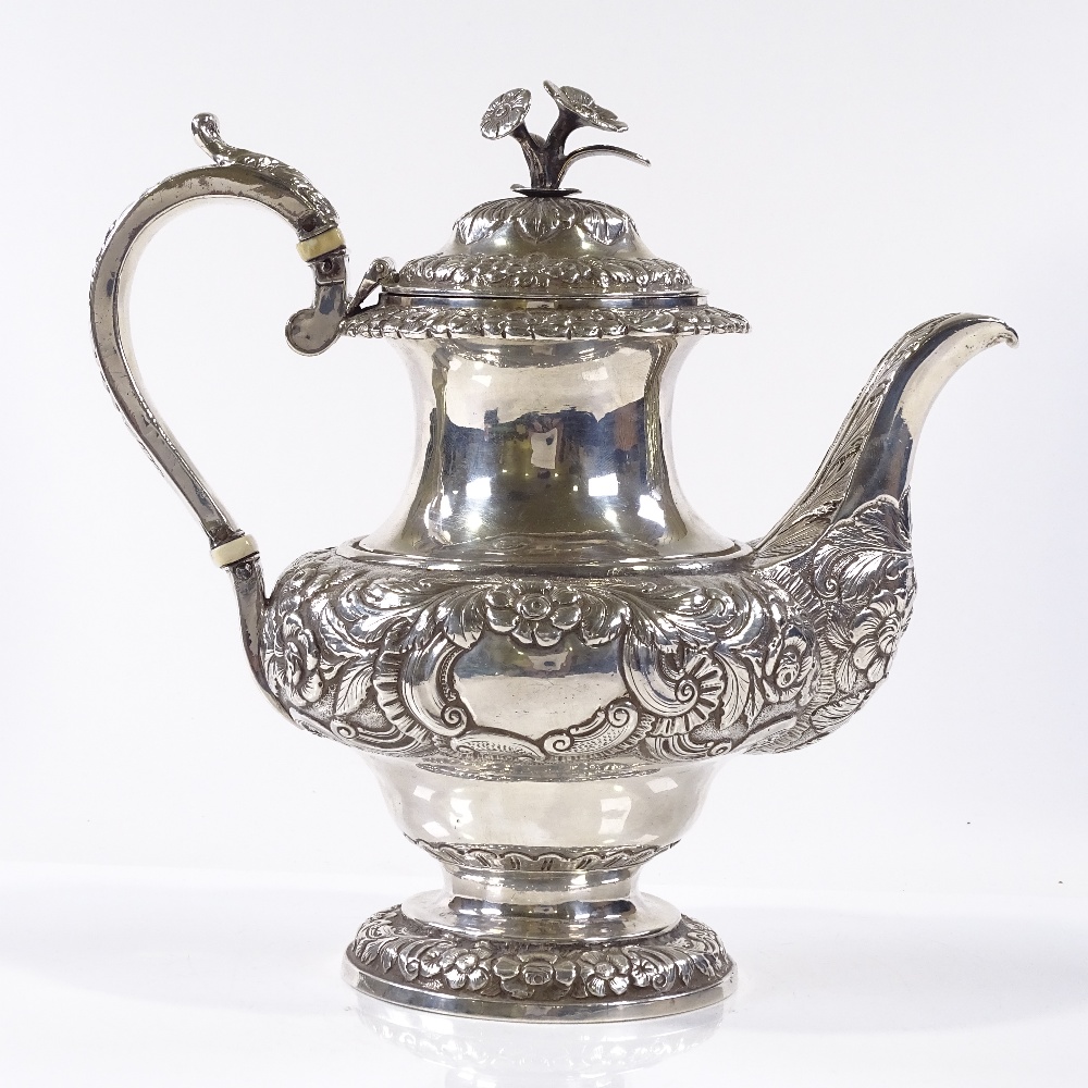 A George IV Irish silver coffee pot, with relief embossed floral and foliate decoration, with - Image 2 of 4