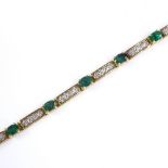 A 10ct gold emerald and diamond tennis line bracelet, length 18cm, 8.3g