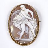 An oval relief carved cameo shell brooch, depicting Hercules and the Nemean Lion, in unmarked yellow