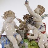 A Naples porcelain group of cherubs with a caged bird, height 22cm, length 23cm