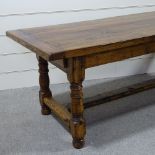 A good quality oak refectory style dining table, with 2" thick plank top, turned supports and