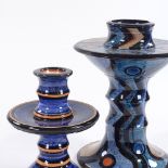 Madoline Keeler (British born 1942), 2 geometric pattern glazed pottery candlesticks, initial on