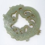 A Chinese carved and pierced jade disc, with dragon decoration, diameter 10cm.