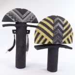 A basalt and geometric patterned totemic ceramic sculpture, with hair and feather additions,