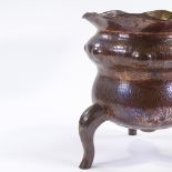 A Victorian Arts and Crafts copper jardiniere on 3 feet, height 26cm, diameter 24cm