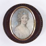 A Georgian circular lacquer snuffbox, with inset miniature watercolour on ivory, portrait of a young