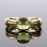 A modern 18ct gold cabochon peridot band ring, setting height 7.3mm, size P, 6.1g