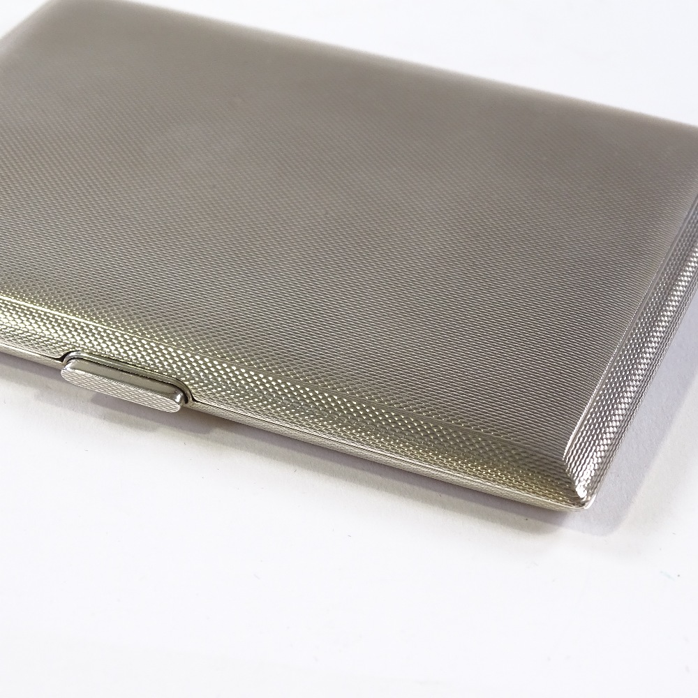 A rectangular silver cigarette case, with gilded interior, by Garrard & Co Ltd, hallmarks Birmingham