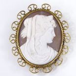 An oval relief carved cameo shell panel brooch, depicting Classical female portrait, in 9ct gold