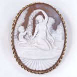 A relief carved cameo panel brooch, depicting Classical maiden and boy, in 9ct gold twist frame,