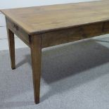 An Antique French fruitwood farmhouse table with 1" thick plank top, 3 frieze drawers and tapered