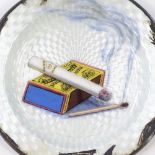 A sterling silver and enamel ashtray, with cigarette and matchbox design, diameter 8.5cm, 1.7oz (