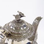 A George IV Irish silver coffee pot, with relief embossed floral and foliate decoration, with