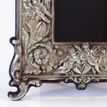 A modern Britannia standard silver-fronted photo frame, with high relief flower and cherub