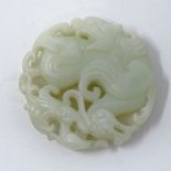 A Chinese carved and pierced jade disc, with dragon decoration, diameter 5.5cm.