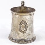 An Edwardian silver mug, of tapering form with acanthus leaf handle and gilded interior, by Josiah