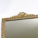 An Antique carved giltwood-framed rectangular wall mirror, with ribbon pediment, width 66cm, overall
