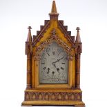A Victorian Gothic light oak-cased bracket clock, with elaborately carved architectural case with