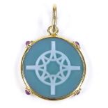 A circular relief carved green agate pendant, with cabochon ruby set 18ct gold frame, pendant