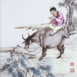 A Chinese porcelain plaque with hand painted scene depicting a figure riding a water buffalo,