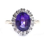 A 9ct gold oval-cut amethyst and diamond cluster ring, setting height 13mm, size L, 3.3g