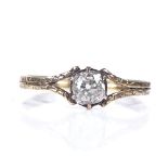 A Georgian unmarked gold solitaire diamond ring, with floral engraved shoulders and shank, diamond