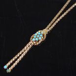 An unmarked gold turquoise knot and double-tassel necklace, with popcorn link chain, necklace length