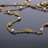 An Antique gilt-metal turquoise and cultured pearl long guard chain, with milled openwork settings