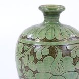 A Chinese green glazed ovoid vase, with incised leaf decoration, height 26cm, and a Chinese blue and