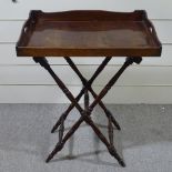 A Georgian mahogany butler's tray on folding stand, 30" x 21"