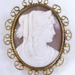 An oval relief carved cameo shell panel brooch, depicting Classical female portrait, in 9ct gold