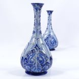 A pair of James Macintyre Burslem Florian Ware narrow-necked vases, with relief floral decoration,