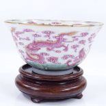 A Chinese porcelain bowl with painted and gilded dragon designs, diameter 11.5cm, A/F