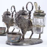 A pair of Victorian electroplate table cruets, supported by goats, original cut-glass mounts, height