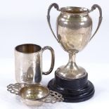 A silver 2-handled trophy on stand, silver tea strainer, and silver christening mug, 6.3oz weighable