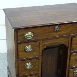 A George III mahogany kneehole writing desk of small size, with drawers and alcove cupboard, width