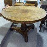 A William IV circular mahogany tilt-top dining table, on tulip carved centre column, and shaped