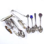 Various silverware, including sugar tongs, teaspoons, and fruit knives