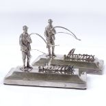 A pair of silver menu holders, designed as fly fishermen, by Henry Williamson Ltd, hallmarks