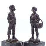 A pair of miniature bronze figures of Italian street urchins, circa 1900, on black marble bases,
