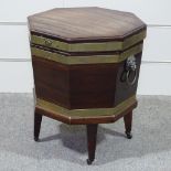 A George III brass-bound mahogany wine cooler of octagonal form, on tapered legs, with brass lion