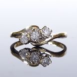 A 9ct gold 3-stone diamond crossover ring, total diamond content approx 0.25ct, setting height 7.