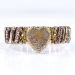 An Antique silver and gold plated expanding heart clasp bracelet, with engraved floral decoration,