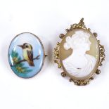 A painted porcelain panel brooch, depicting a Kookaburra, in 9ct frame, height 27mm, together with a