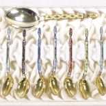 A set of 12 Norwegian sterling silver-gilt and coloured enamel coffee spoons, and matching caddy