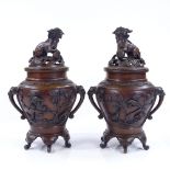 A pair of Oriental patinated bronze vases and covers, with Dog of Fo knops and bird decorated relief